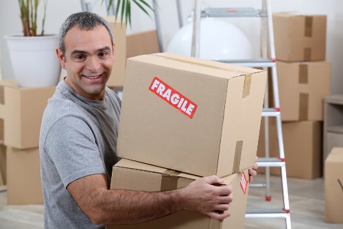 Removal team handling household items during a Wimbledon home move