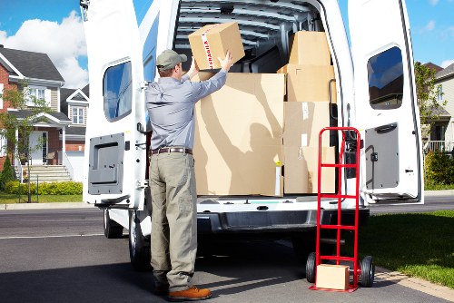 Removals team carrying household items through a Wimbledon apartment building
